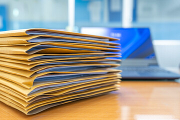 Wall Mural - Stacks of Brown envelope, piles of unfinished documents, Business report papers, Using scanner machine for convert document to digital data storing into computer.