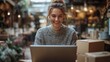 © gacor - Smiling Woman Working on Laptop in a Cafe