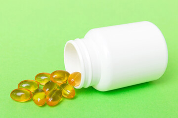 Omega-3 capsules lie in white bottle on a table background. Fish oil tablets top view. Biologically active additives. omega 6, omega 9, vitamin A, E, vitamin D, vitamin D3, evening primrose oil