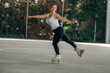 young woman training or doing sports outdoors, skater