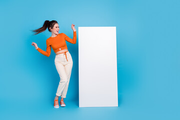 Sticker - Full length photo of impressed millennial brunette lady look poster wear top pants sneakers isolated on blue background