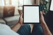 © schmidt - An image of a man using a tablet computer while sitting on the chair with clipping paths on the screen for easy replacement of your design