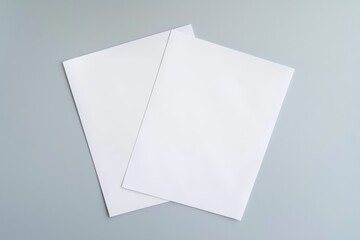 Blank brochure pages on a grey background, viewed from the top.