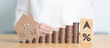 © Jo Panuwat D - Arrow change to UP and Down with percentage, Home model and money coins stack. Real estate Mortgage, Refinance, House loan and debt, Interest rate, Insurance, Financial and Property Tax concepts