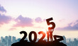 © metamorworks - People holding up the New Year 2025. 2025 New Year concept. New year's card 2025.