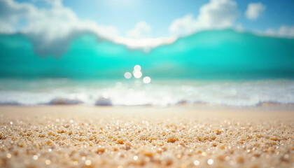 A close-up view of sparkling beach sand glistening in sunlight, with a softly blurred tropical ocean in the background.