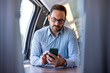 © Dragana Gordic - Professional Businessman Using Smartphone on Train Journey