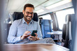 © Dragana Gordic - Businessman Enjoying Train Journey While Using Smartphone
