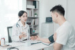 © MrAshi - Asian female doctor and male patient discuss treatment with successful professional physician wearing white lab coat and stethoscope about injury