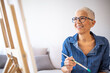 © Dragana Gordic - Smiling Senior Woman Painting In Her Art Studio