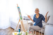 © Dragana Gordic - Senior Woman Enjoying Painting at Home in a Relaxed Setting