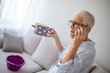 © Dragana Gordic - Concerned Woman Holding Pot While Talking on Phone at Home