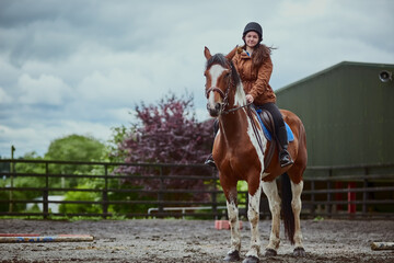 Portrait, horse and child riding on farm for sport, countryside training and equestrian development. Stallion, girl rider and balance for exercise practise, wellness hobby and ranch outdoor of travel