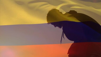 Wall Mural - Animation of flag of colombia over caucasian man on beach