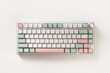 © svetlana_cherruty - Modern mechanical keyboard on white background. Minimal style and design keyboard. Custom build keyboard. Colorful key pastel creamy pink and green cap. Top view.