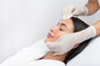 © Home-stock - Beautician cleaning skin by using cotton pads or sponges, relaxed woman getting facial care at spa salon, free space