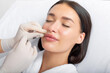 © Home-stock - Beauty specialist making injection in female patient lips, lip augmentation and correction procedure in cosmetology salon