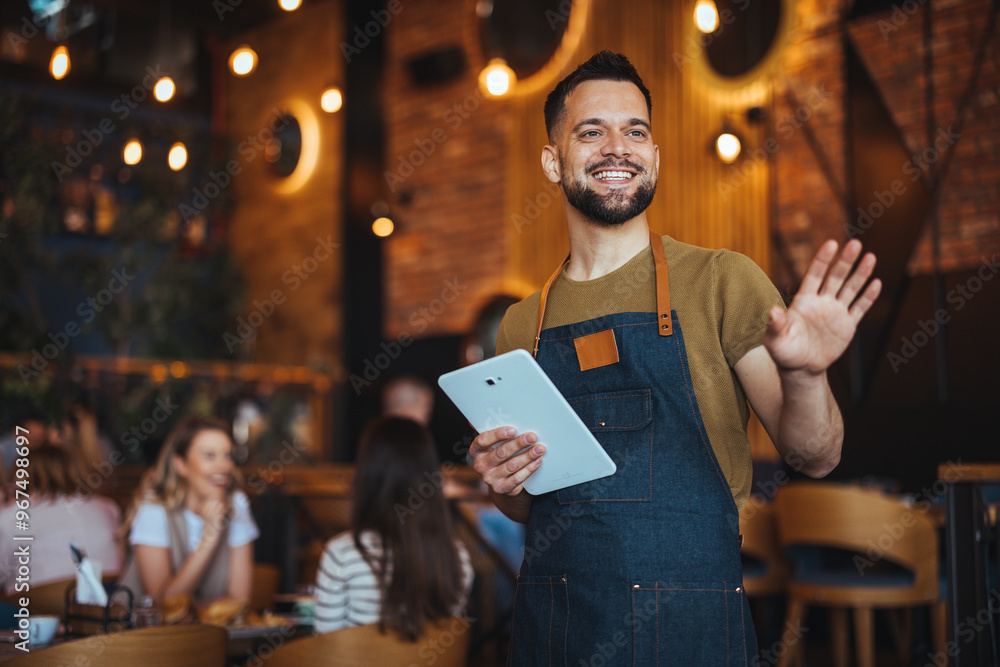 Smiling Waiter Greeting Customers in a Cozy Restaurant Setting Stock ...