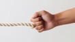 © indirah - Hand Holding a Rope on a White Background