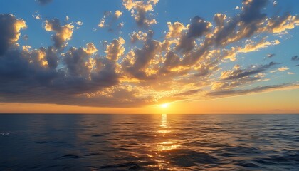 Poster - The vast ocean glows with golden brilliance in the sunset, and the sky is decorated with soft clouds, showing the combination of tranquility and beauty.