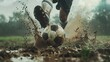 © Bismilah - Soccer Player Kicking a Muddy Ball in a Downpour