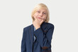 © somemeans - Portrait of a cute little boy with blond hair in a suit holding his chin
