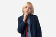© somemeans - Portrait of pensive young man with blond hair, wearing blue jacket and red tie, looking with thoughtful expression, isolated over white background