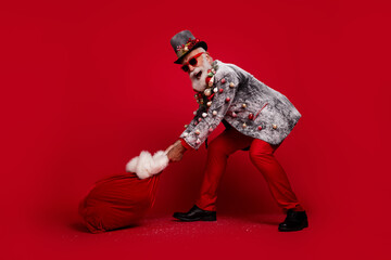 Canvas Print - Full body photo of santa claus man pull deliver present sack dressed christmas tree balls costume sunglasses isolated red color background