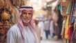 © BerkahStock - A man in traditional attire stands in a vibrant market filled with textiles and crafts.