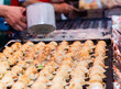 © torjrtrx - Close up of Takoyaki, famous japanese street food in Takoyaki shop.