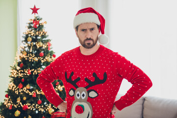 Sticker - Portrait of nice young man put hands waist sullen face ugly sweater new year atmosphere flat indoors