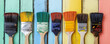 © Oleksandr - Various paintbrushes display bright colors lined up on painted wooden planks for home improvement