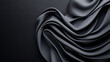 © khonkangrua - Flowing black silk fabric draped elegantly on a dark surface, creating a luxurious, dramatic, and textured effect for fashion or decor themes.