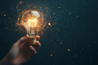 © wolfhound911 - A human hand holding a glowing lightbulb, emitting swirling lines of light and particles, representing an inspiring idea on a dark gradient background.