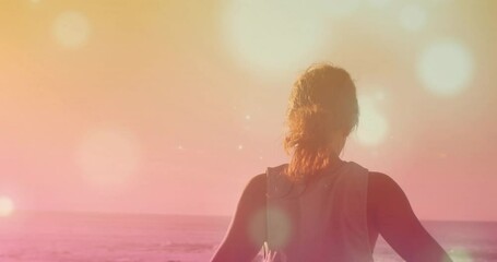 Wall Mural - animation of light spots over biracial woman practicing yoga at beach
