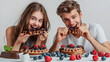 © Володимир Кучмійов - Happy teenagers enjoying a messy chocolate-filled waffle dessert, expressing fun, laughter, and sweet indulgence in a moment of carefree enjoyment