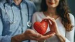 © Virtual Art Studio - Doctor and patient holding a red heart, symbolizing healthcare and compassion.