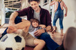 © Marko Geber - Father playing soccer with son on patio
