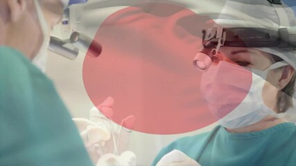 Sticker - Animation of flag of japan over caucasian surgeons during surgery