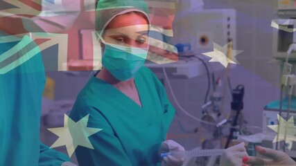 Wall Mural - Animation of flag of australia over caucasian surgeons during surgery