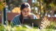 © vanzerim - Young Woman Working on Laptop in the Park
