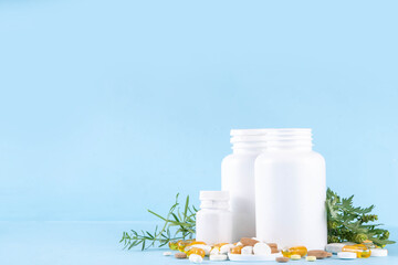 Wall Mural - Homeopathic medicine pills, various colorful medicine pills and capsules, dietary supplements with herbs and plants.. Natural and alternative medicine, Eco organic medicine concept