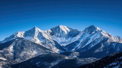 Sticker - Majestic snow-capped mountains under a clear blue sky.