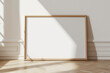 © timitinej - Horizontal frame on floor mockup blank poster. Wooden frame mock up empty print background. Wood picture frame in room. Gallery design modern interior