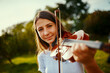 © StarDweller/peopleimages.com - Girl, violin and portrait in nature for music, talent and entertainment for event. Musician, string instrument and smile on grass for art, rehearsal and practice for creativity with skill development