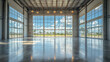 © Vertigo Images - Empty hangar with large windows showcasing a bright sky.