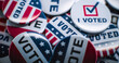© Framestock - Close up of patriotic badges with American flag logo and inscription Vote. Election Day in the United States of America. Political race and presidential campaign. Democracy and patriotism concept.