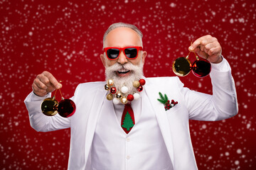 Sticker - Photo of funky charming age gentleman wear new year costume dark eyewear holding red balls isolated red color background