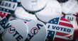 © Framestock - Close up of patriotic badges with American flag logo and inscription. Presidential elections in the United States of America. Political race and election coverage. Democracy and patriotism concept.