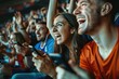 © Fotograf - Group of people gathered around a cell phone watching a video in a stadium setting